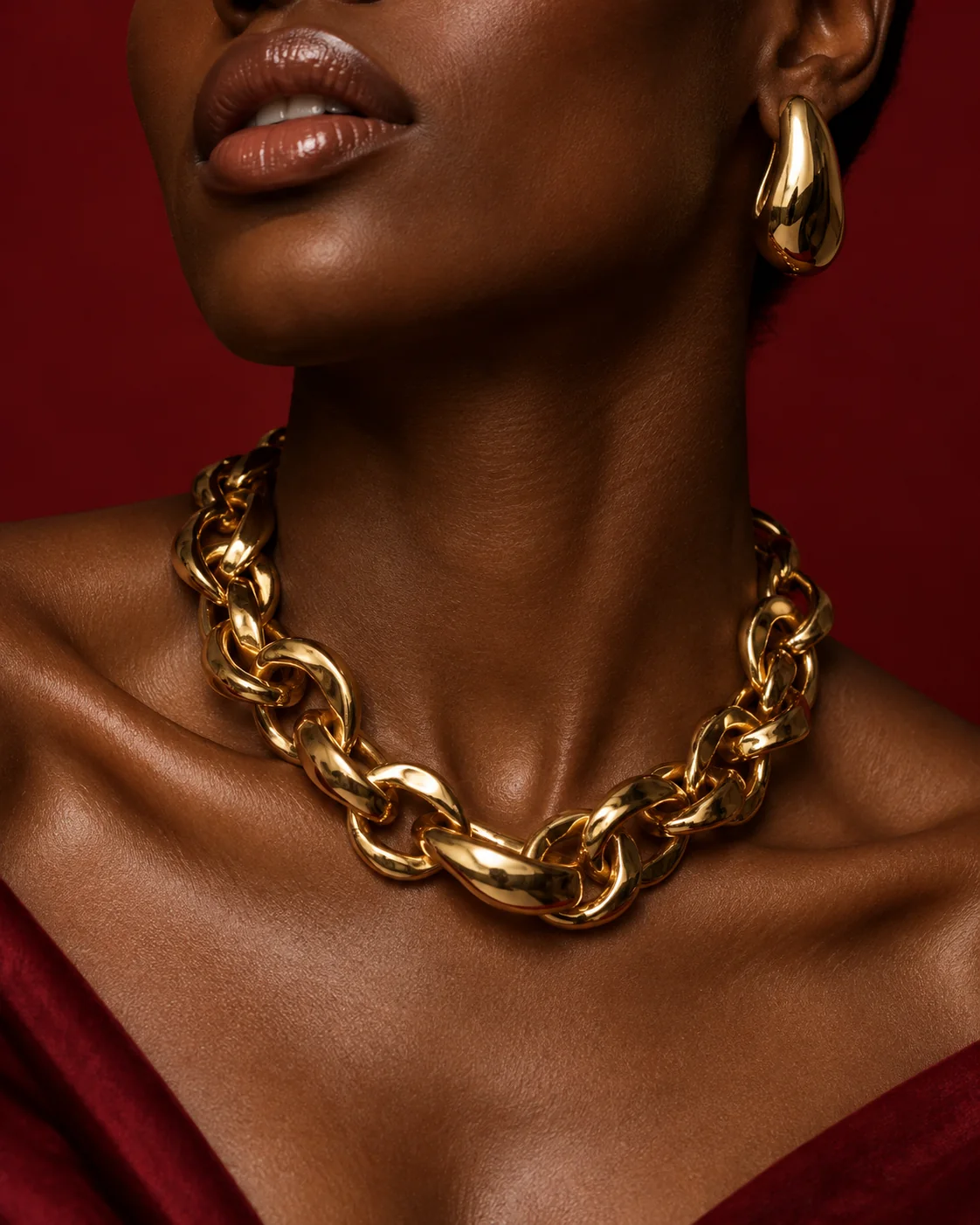 Close portrait of a model wearing a gold necklace and earring